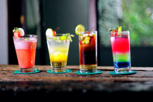 tropical mixed drinks with fruit in various colors