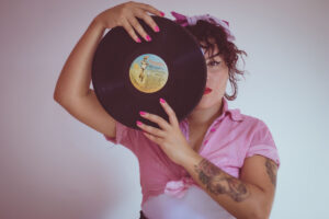 women with vinyl record over one eye